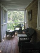 Screened porch with nice wicker furniture